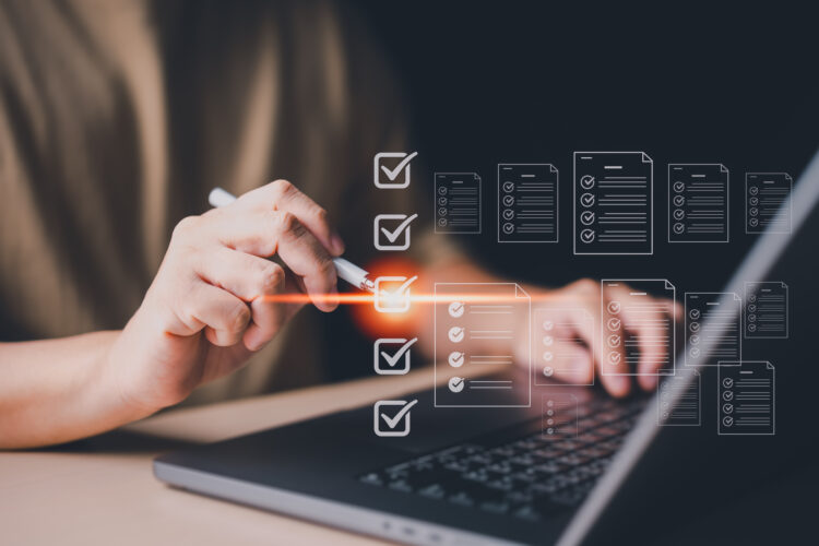 Businessman use a laptop to take online surveys with digital forms and checklists. Technology and strategy for success in modern business trends. Efficiency, transparency in organization and company.